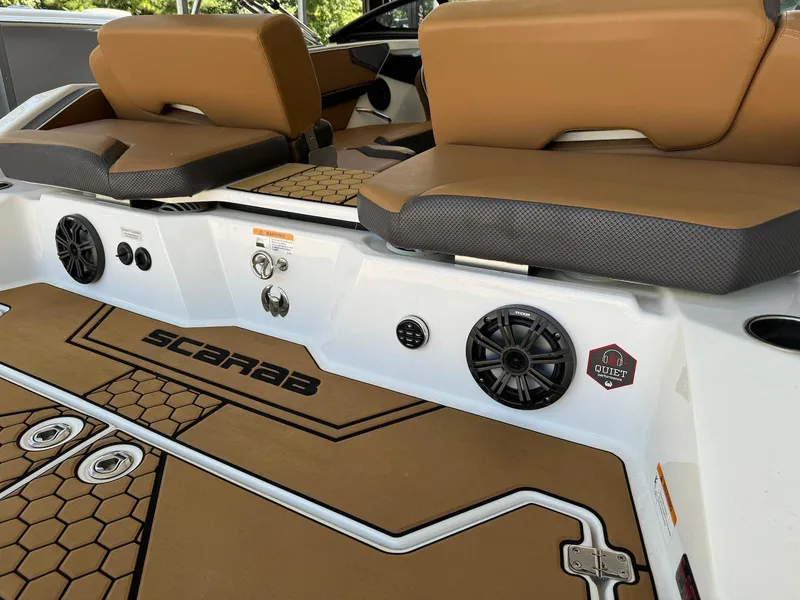 Slide: The Image of 2021 Scarab 215 ID boat interior with brown seating and audio system. - 5