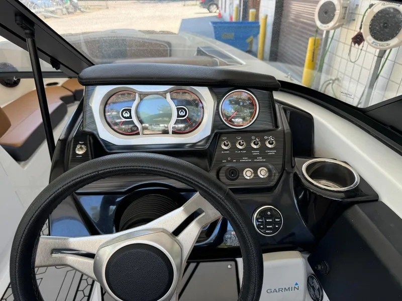 Slide: The Image of Cockpit of 2021 Scarab 215 ID boat with steering wheel and control panel. - 8
