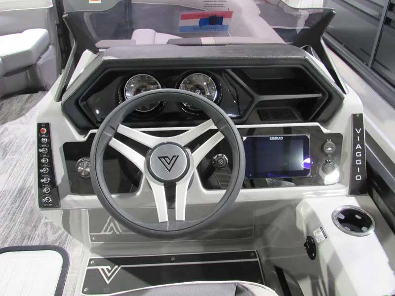 Slide: The Image of 2025 Viaggio Z22Q boat dashboard with steering wheel, digital display, and control panel. - 11