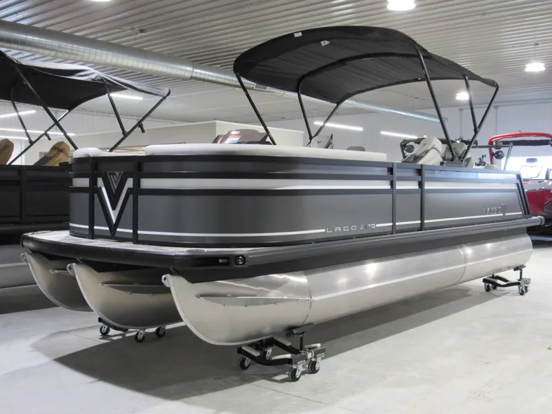 Slide: The Image of 2025 Viaggio Z22Q pontoon boat in showroom with sleek design and canopy. - 2