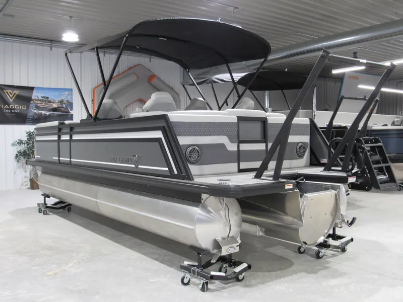 Slide: The Image of 2025 Viaggio Z22Q pontoon boat in showroom, featuring sleek design and modern canopy. - 3
