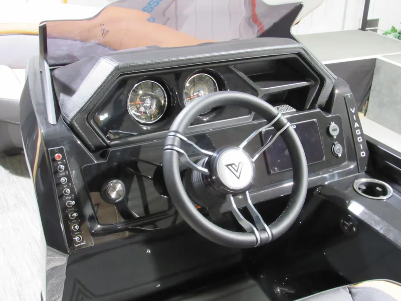 Slide: The Image of 2025 Viaggio Z22S boat dashboard with steering wheel, gauges, and control panel. - 11