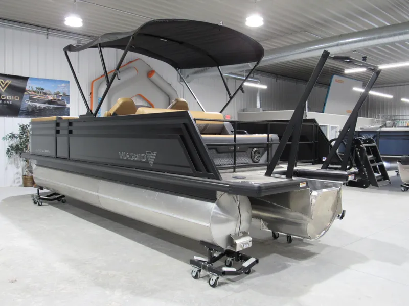 Slide: The Image of 2025 Viaggio Z22S pontoon boat in showroom, featuring sleek design and canopy. - 3