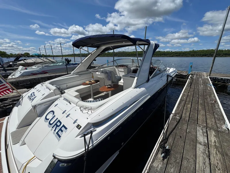 Slide: The Image of 2011 Regal 3350 Cuddy boat docked on a sunny day with blue skies. - 13