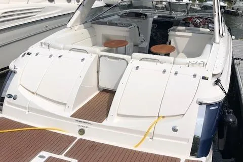 Slide: The Image of 2011 Regal 3350 Cuddy boat with spacious seating and wooden deck at a marina. - 16