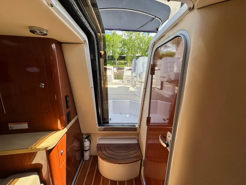 Slide: The Image of Interior of 2011 Regal 3350 Cuddy boat, featuring wood accents and outdoor view. - 41