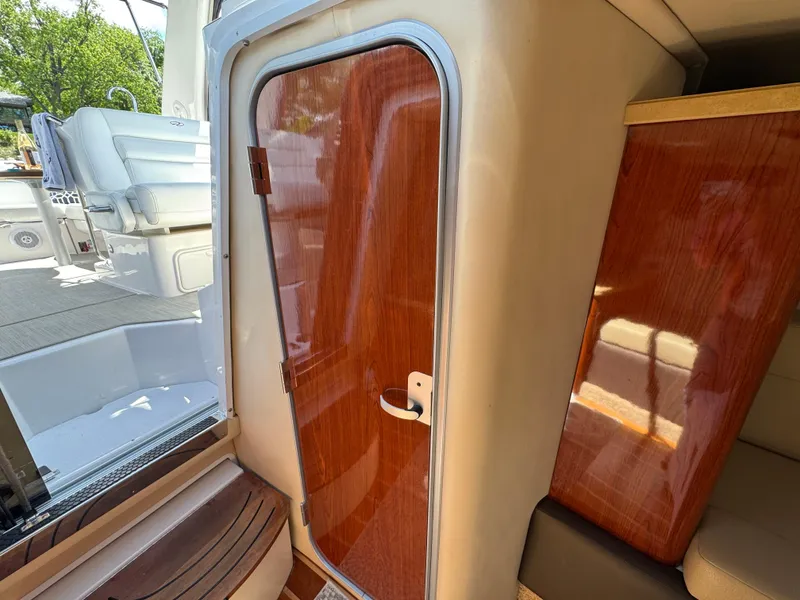 Slide: The Image of 2011 Regal 3350 Cuddy interior with wooden door and seating area. - 42