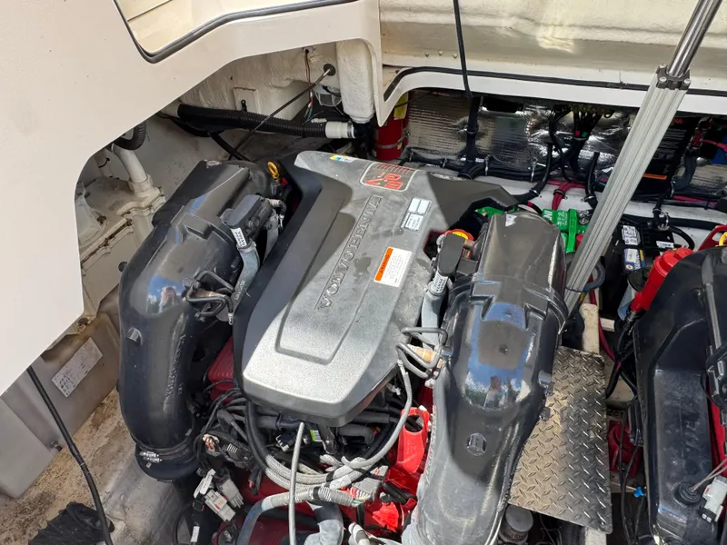 Slide: The Image of Engine compartment of a 2011 Regal 3350 Cuddy boat, showcasing detailed mechanical components. - 47