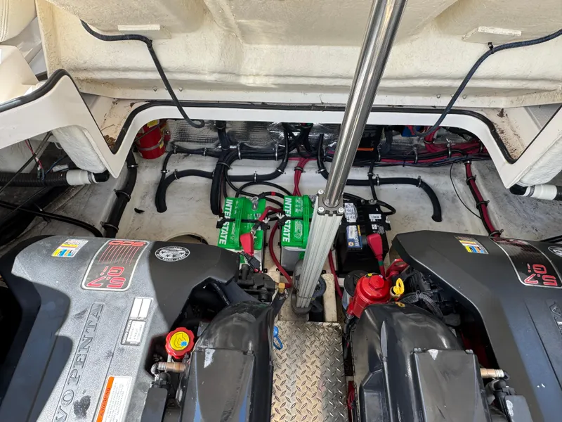 Slide: The Image of Engine compartment of a 2011 Regal 3350 Cuddy boat, featuring dual engines and batteries. - 48