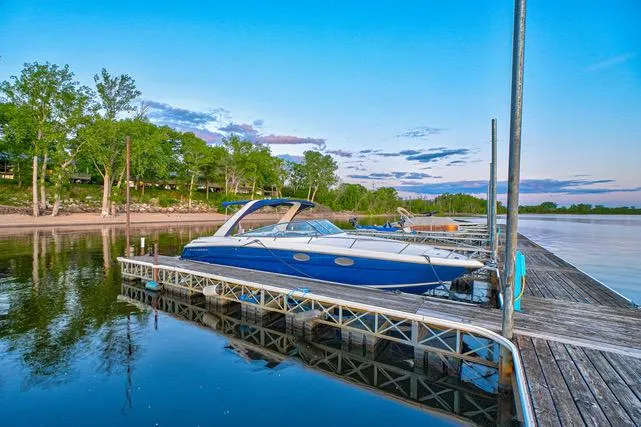Slide: The Image of 2011 Regal 3350 Cuddy boat docked on calm water at sunset. - 5