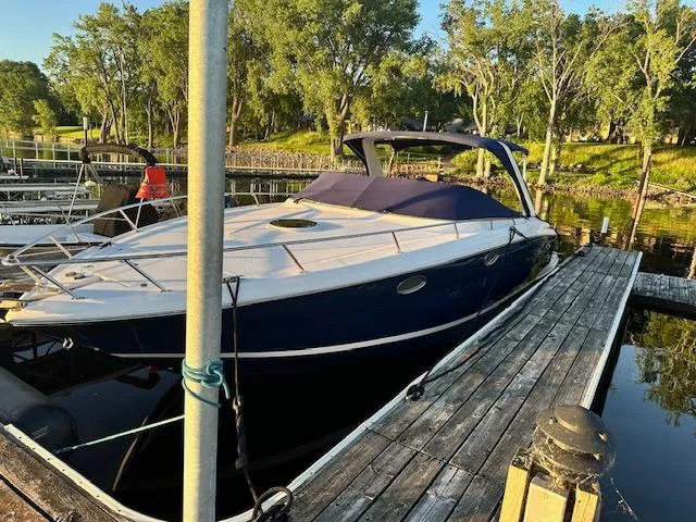 Slide: The Image of 2011 Regal 3350 Cuddy boat docked by a scenic lakeside. - 7