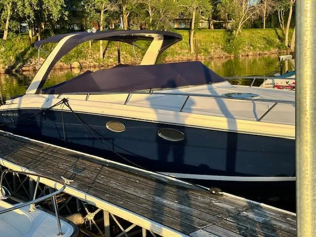 Slide: The Image of 2011 Regal 3350 Cuddy boat docked by a scenic lakeside. - 8