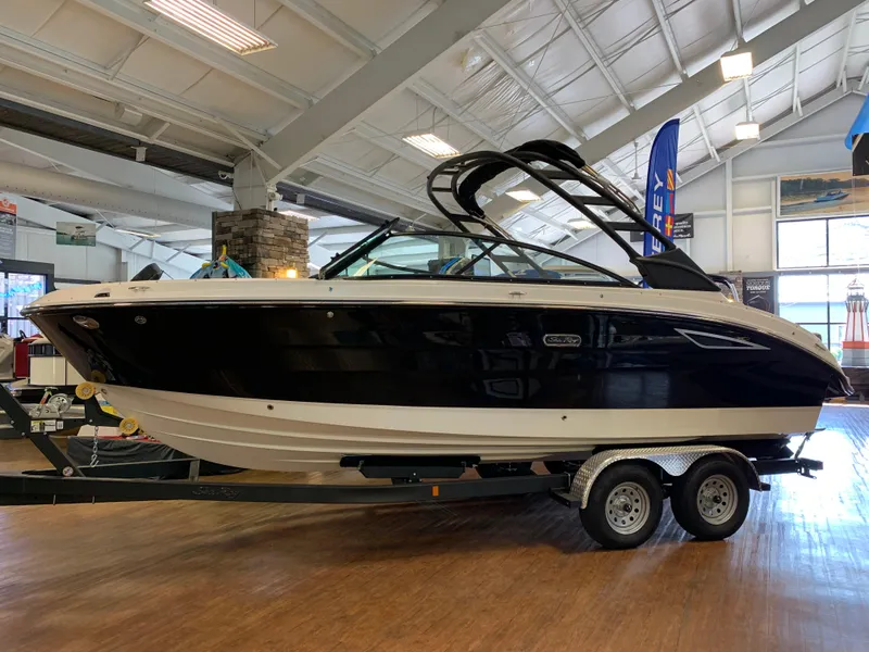 The Image of 2025 Sea Ray SDX 250 boat on trailer in showroom setting. - 0