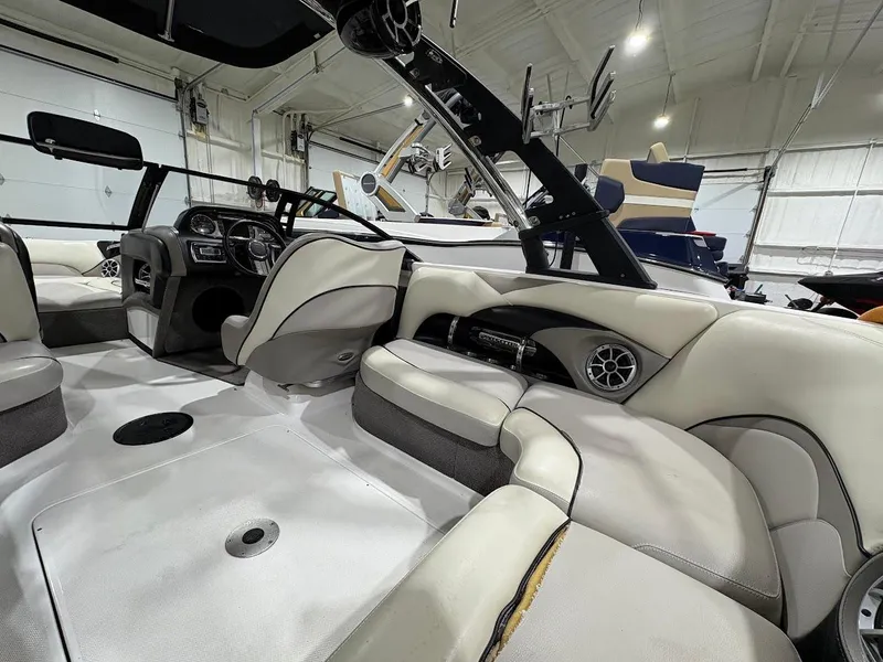 Slide: The Image of Interior of a 2011 Malibu Wakesetter 21 VLX boat with plush seating and modern dashboard. - 12