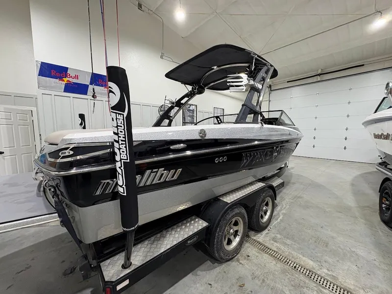 Slide: The Image of 2011 Malibu Wakesetter 21 VLX boat on trailer in indoor storage. - 3