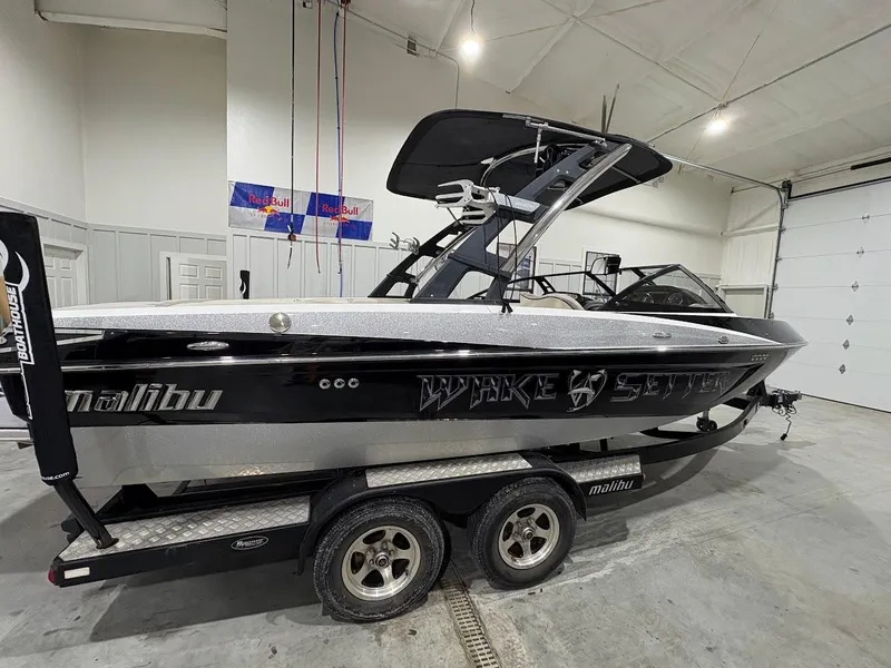 Slide: The Image of 2011 Malibu Wakesetter 21 VLX boat in a garage on a trailer. - 4
