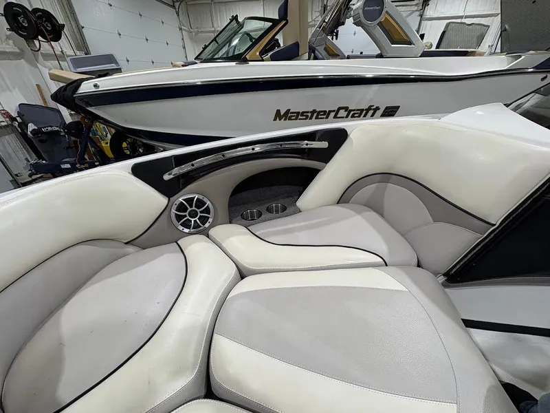 Slide: The Image of Interior of a 2011 Malibu Wakesetter 21 VLX boat with a MasterCraft in the background. - 8