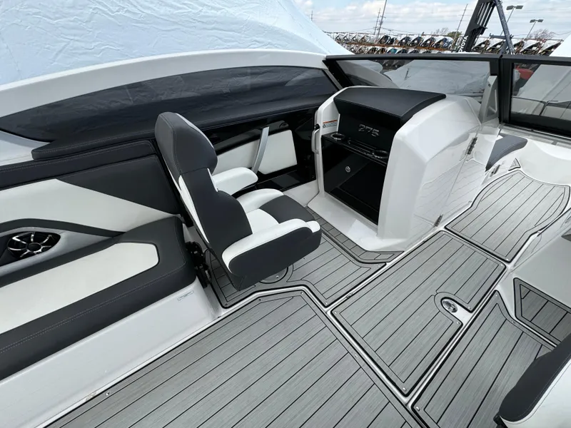 Slide: The Image of 2021 Yamaha Boats 275SE interior with sleek seating and modern dashboard design. - 10