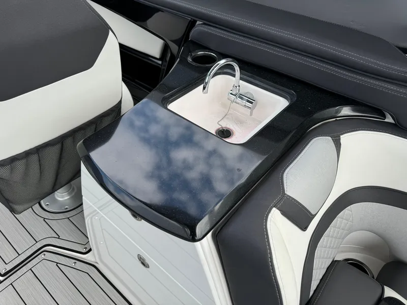 Slide: The Image of 2021 Yamaha Boats 275SE interior with sleek sink and seating area. - 16
