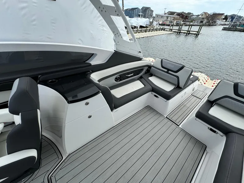 Slide: The Image of 2021 Yamaha Boats 275SE interior with sleek seating and waterfront view. - 20