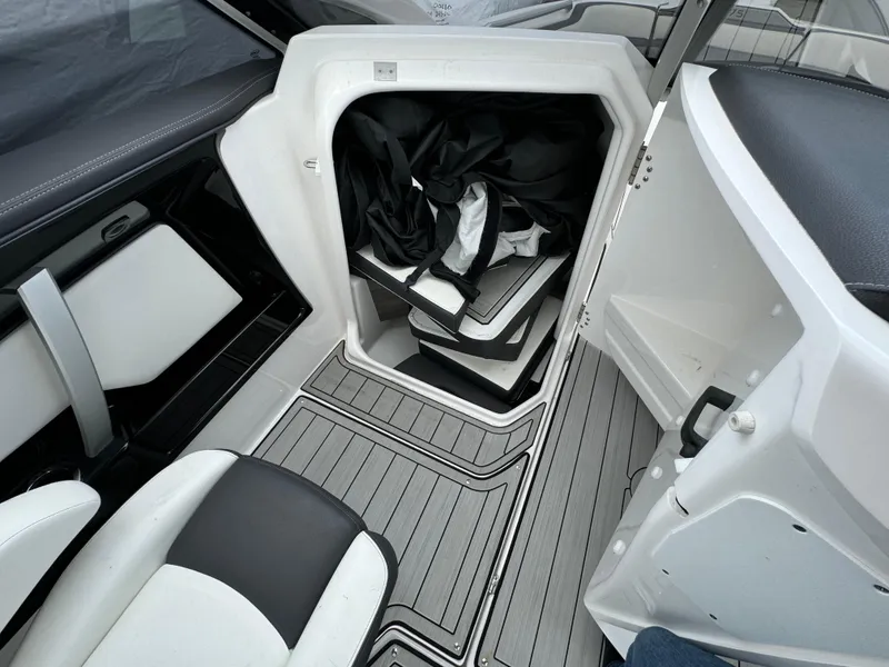 Slide: The Image of 2021 Yamaha Boats 275SE interior storage compartment with seating and flooring details. - 21