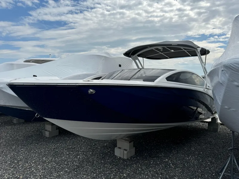 Slide: The Image of 2021 Yamaha Boats 275SE, sleek design, docked under cloudy sky. - 4