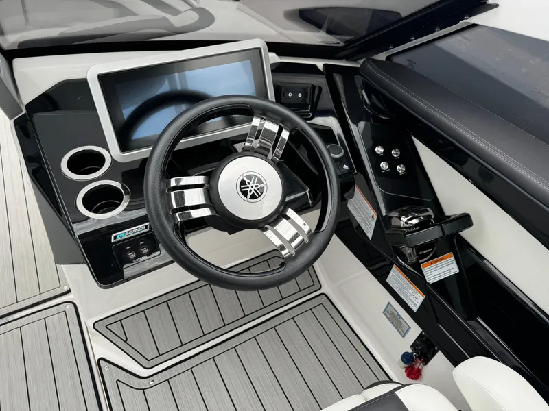 Slide: The Image of 2021 Yamaha Boats 275SE dashboard with steering wheel and digital display. - 9