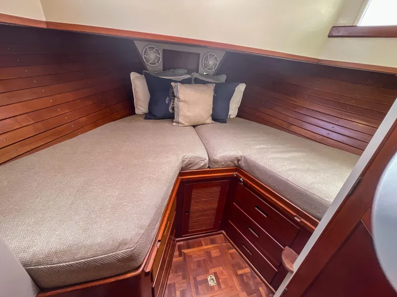 Slide: The Image of Cozy cabin interior of 1989 Grand Banks 42 Classic with wooden paneling and cushioned bedding. - 11