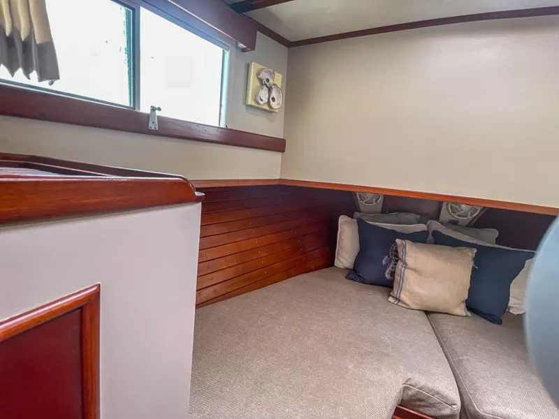 Slide: The Image of Cozy cabin interior of 1989 Grand Banks 42 Classic with cushions and wooden accents. - 13