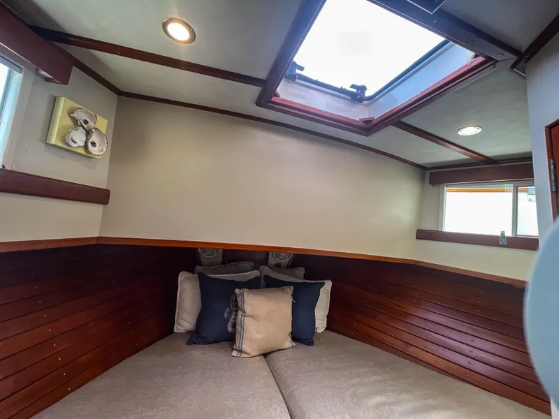 Slide: The Image of Cozy cabin interior of 1989 Grand Banks 42 Classic yacht with skylight and cushions. - 14