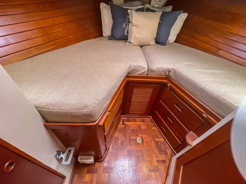 Slide: The Image of 1989 Grand Banks 42 Classic cabin with wooden interior and cozy bedding. - 15