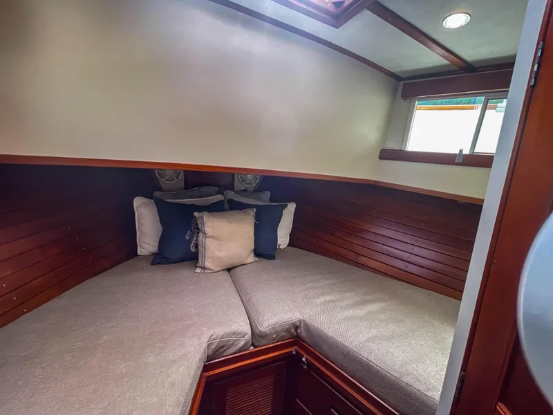 Slide: The Image of Cozy cabin interior of 1989 Grand Banks 42 Classic with plush bedding and wooden accents. - 16