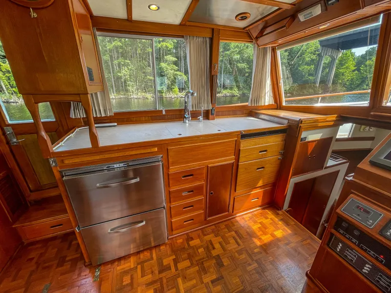 Slide: The Image of Interior of 1989 Grand Banks 42 Classic yacht with wooden cabinetry and large windows. - 22