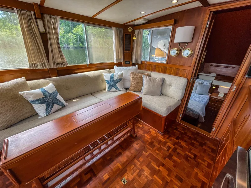 Slide: The Image of 1989 Grand Banks 42 Classic yacht interior with cozy seating and nautical decor. - 24