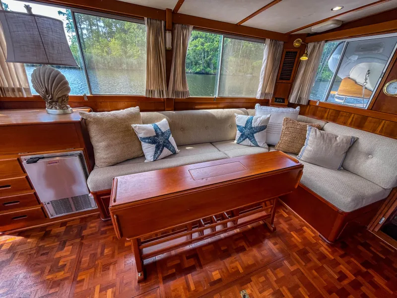 Slide: The Image of Cozy interior of 1989 Grand Banks 42 Classic yacht with plush seating and wooden accents. - 25