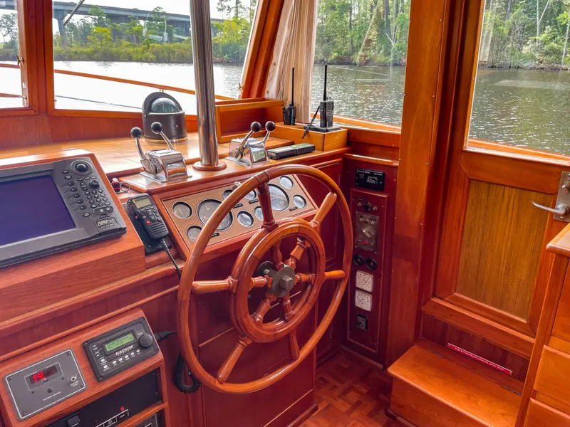 Slide: The Image of 1989 Grand Banks 42 Classic helm with wooden wheel and navigation instruments. - 28