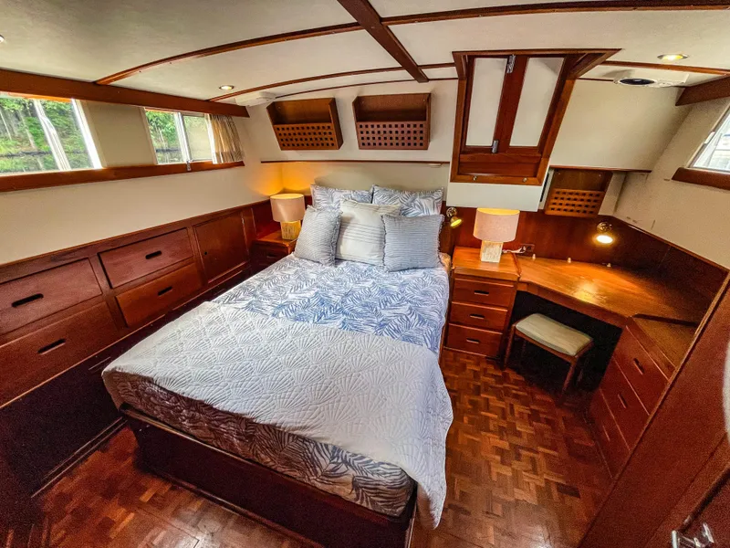 Slide: The Image of Luxurious cabin interior of 1989 Grand Banks 42 Classic yacht with cozy bed and wooden furnishings. - 33