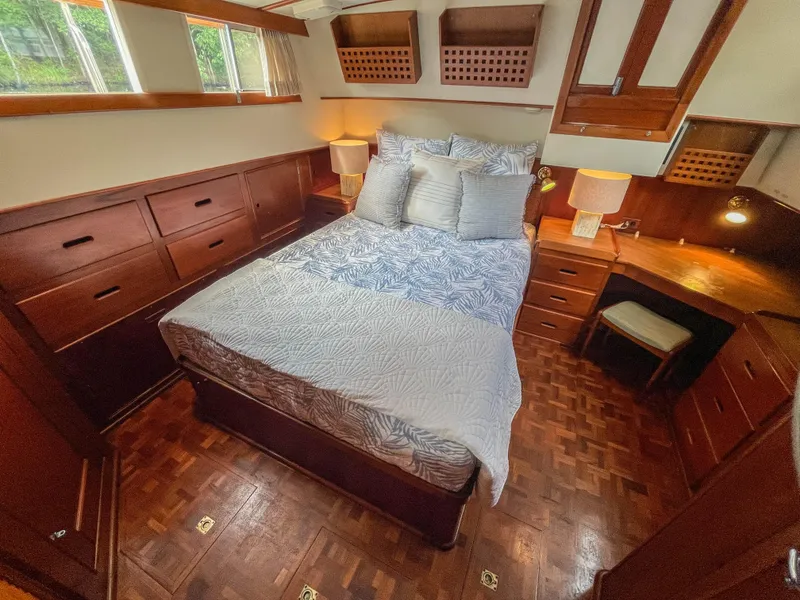 Slide: The Image of Cozy bedroom in 1989 Grand Banks 42 Classic yacht with wooden furnishings and natural light. - 34