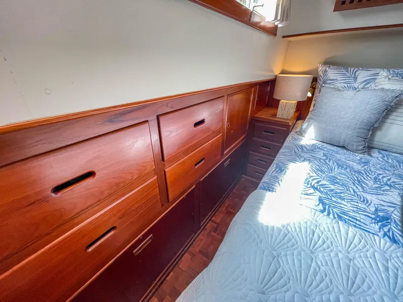 Slide: The Image of Wooden cabin interior of 1989 Grand Banks 42 Classic yacht with bed and storage drawers. - 36