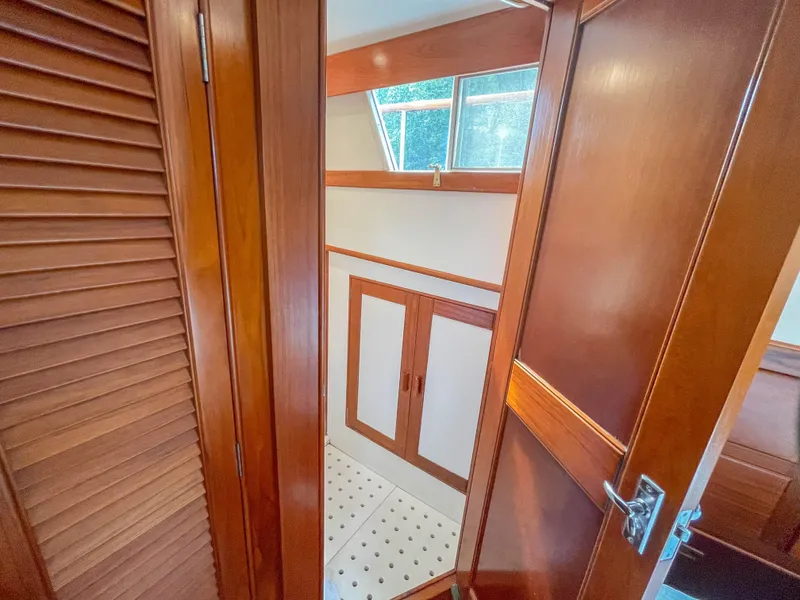 Slide: The Image of 1989 Grand Banks 42 Classic interior with wooden cabinetry and window. - 37
