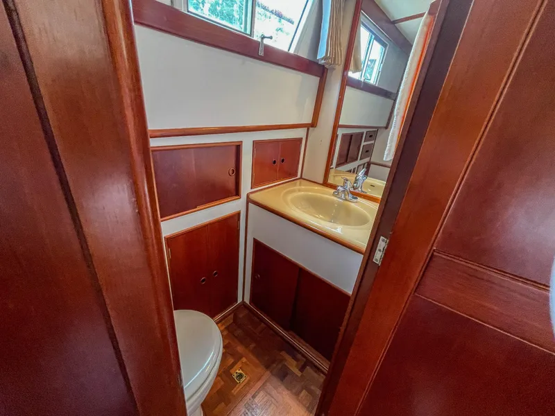 Slide: The Image of 1989 Grand Banks 42 Classic yacht bathroom with wooden cabinetry and sink. - 40