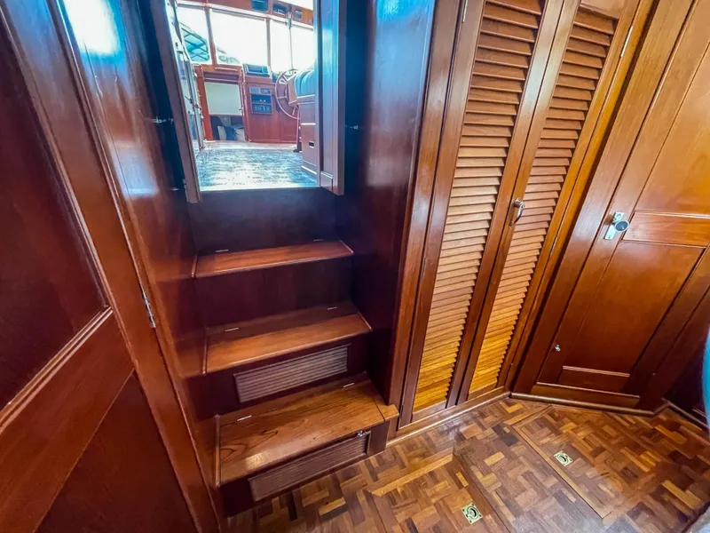 Slide: The Image of Interior of 1989 Grand Banks 42 Classic yacht with wooden stairs and cabinetry. - 43