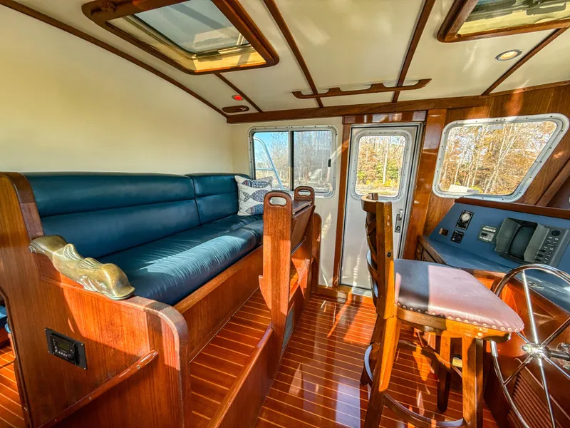 Slide: The Image of Luxurious interior of 2000 Cherubini Independence yacht with wooden finishes and blue seating. - 14