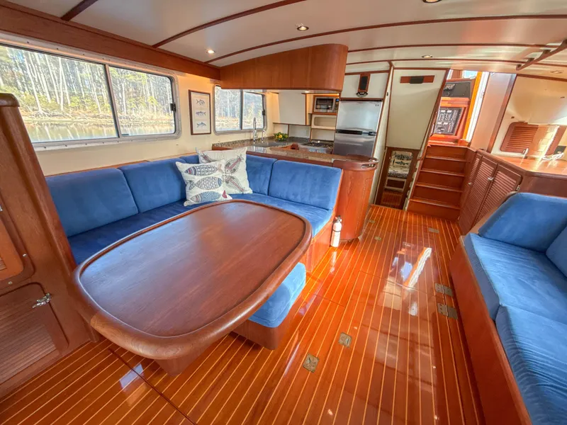 Slide: The Image of Luxurious 2000 Cherubini Independence yacht interior with elegant wood finishes and blue seating. - 18