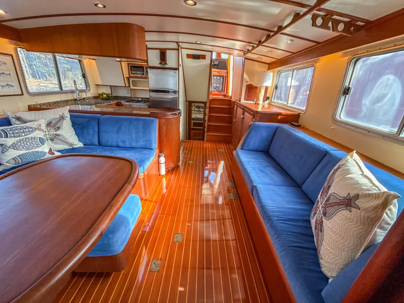Slide: The Image of Luxurious interior of a 2000 Cherubini Independence yacht with blue seating and wooden finishes. - 21