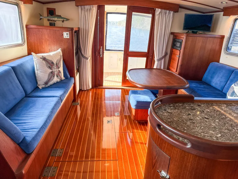 Slide: The Image of Luxurious 2000 Cherubini Independence yacht interior with blue seating and polished wood flooring. - 22