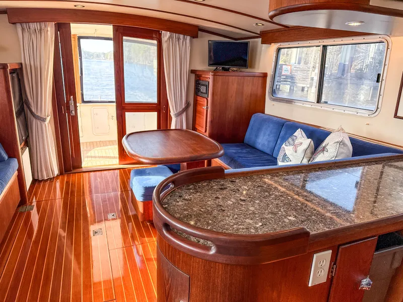 Slide: The Image of Luxurious interior of 2000 Cherubini Independence yacht with wood flooring and blue seating. - 23