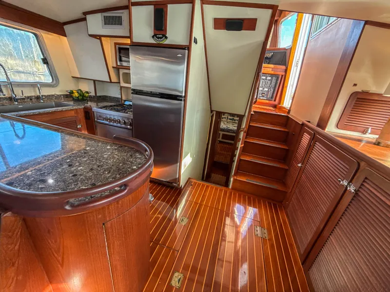 Slide: The Image of Luxurious 2000 Cherubini Independence yacht interior with wood finishes and modern kitchen amenities. - 32