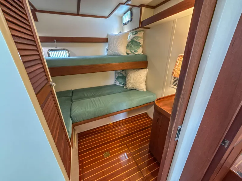 Slide: The Image of Cozy cabin with bunk beds in 2000 Cherubini Independence yacht, featuring wood accents and soft lighting. - 33