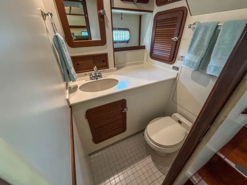 Slide: The Image of Compact bathroom in 2000 Cherubini Independence yacht with sink, toilet, and wooden accents. - 37